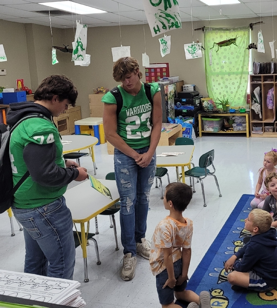 High school football team dropped by the elementary school this afternoon to read to the students. 